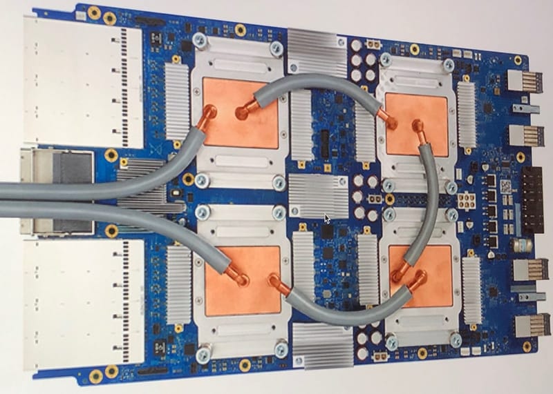 Close-up of a Google Tensor Processing Unit 3.0 board with its chips and heat sinks
