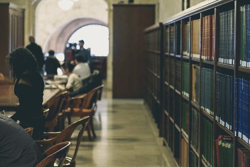 Rows of wooden bookshelves filled with books in the New York Public Library's Stephen A. Schwarzman Building