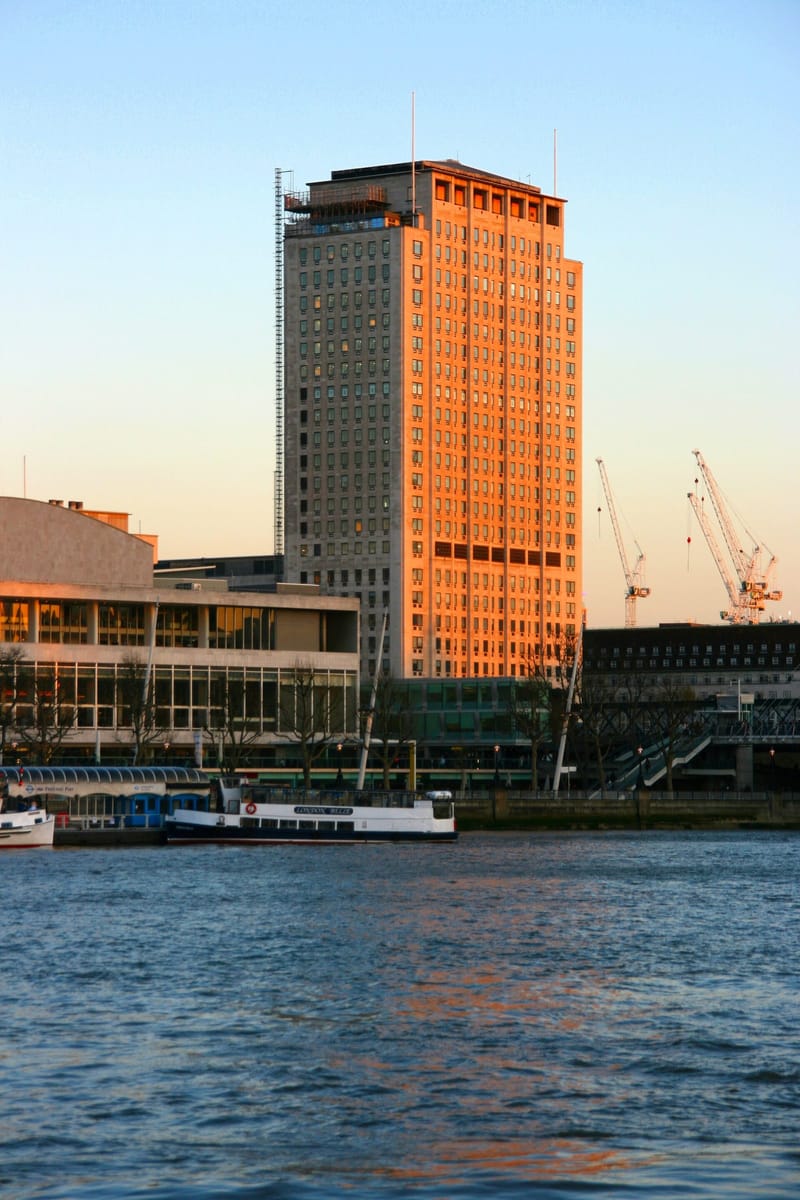 Shell Centre office tower in London, headquarters of Shell plc, in sunset light