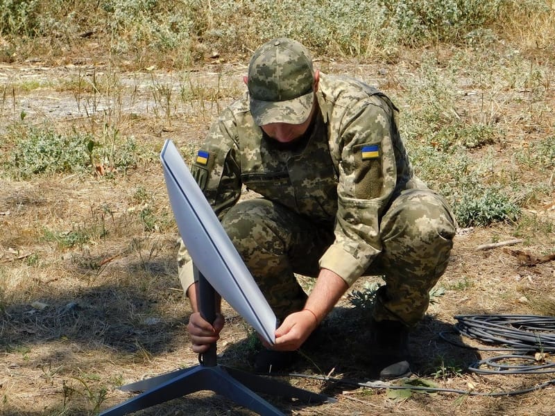 A Ukrainian Support Forces soldier installing a Starlink satellite internet terminal