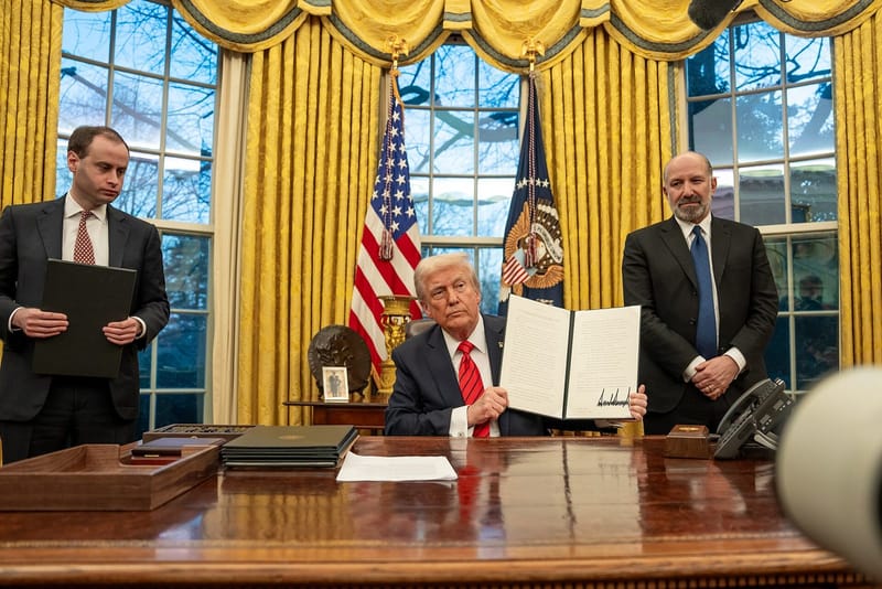 President Donald Trump signs executive orders in the Oval Office on February 10, 2025
